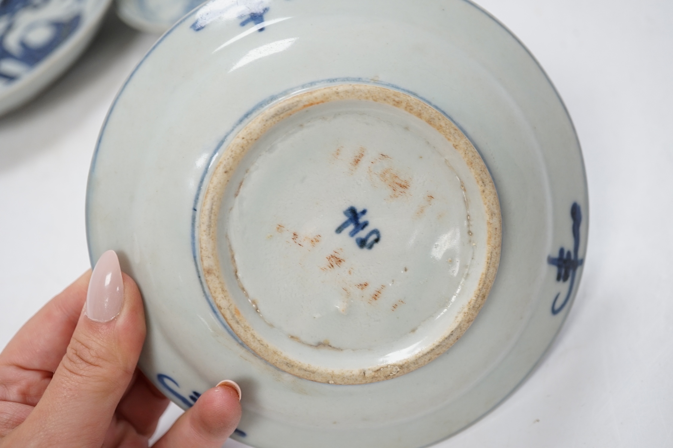 A group of 18th/19th century Chinese blue and white saucers and shallow dishes, largest 18cm in diameter. Condition - varies, mostly fair